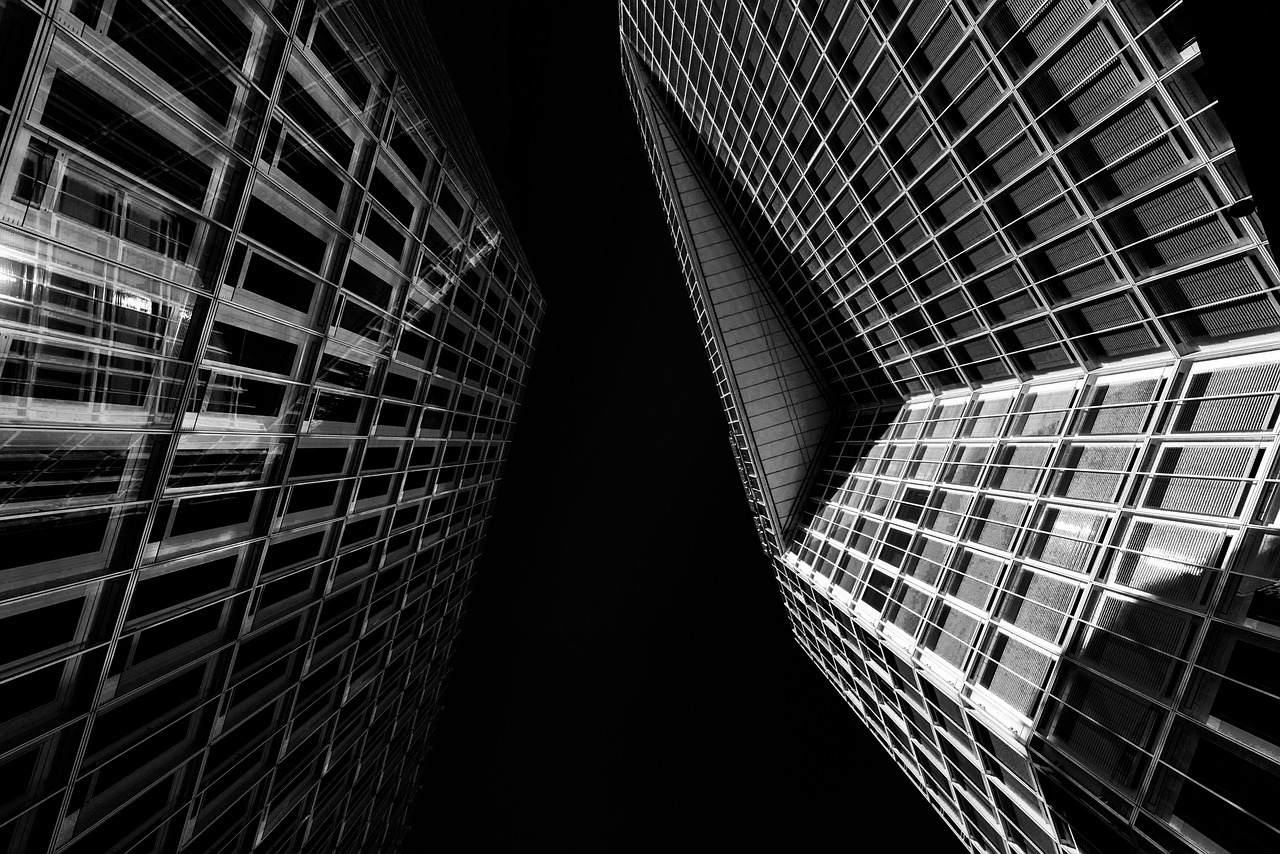 A high-rise commercial office building with a modern glass facade reflecting the sky.