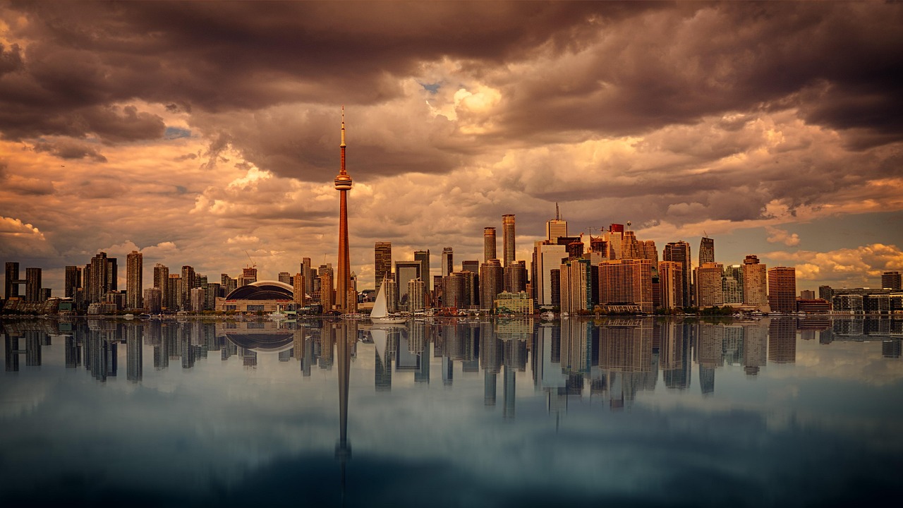 Composite image of London's Canary Wharf and Toronto's financial district.