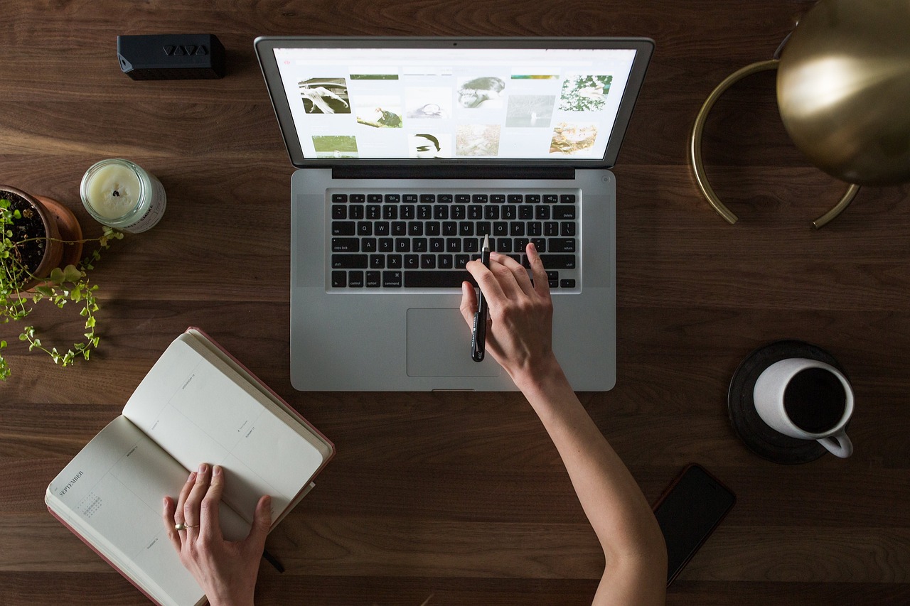 A clean workspace with a financial planner, a calculator, and a laptop representing strategic asset allocation.