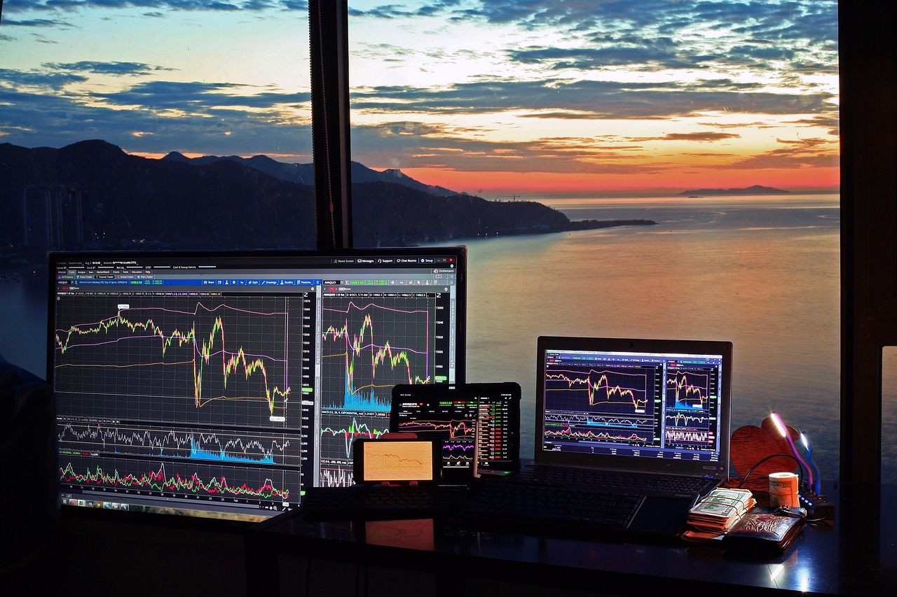 A digital tablet displaying professional financial growth charts and stock market data on a designer desk