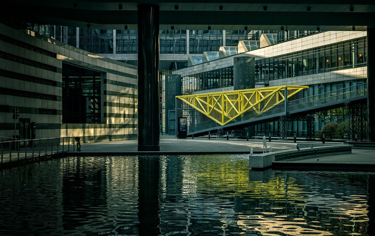 The architectural exterior of a modern glass-clad financial institution at dusk.