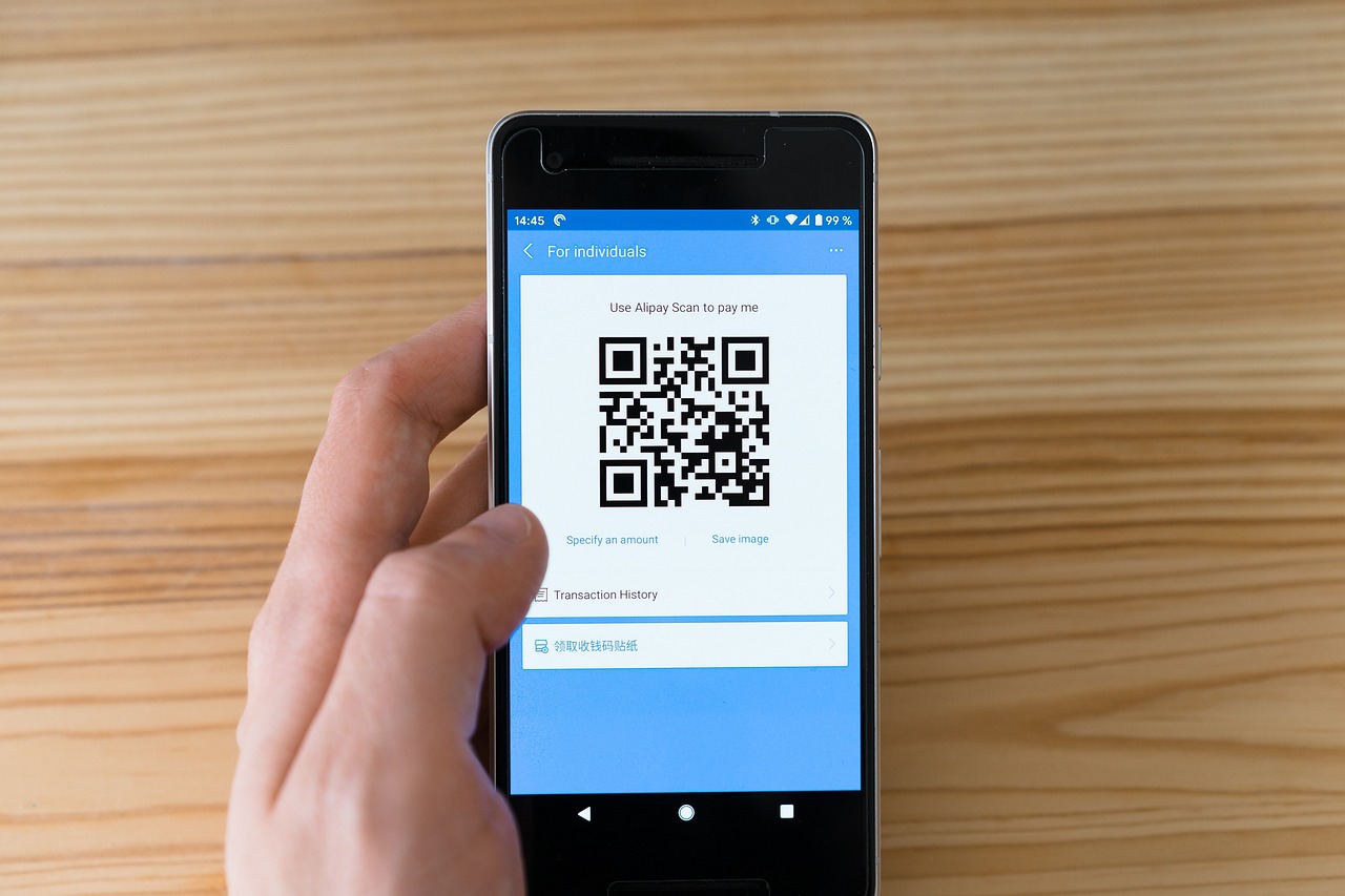 Close up of hands using a mobile phone to complete a fast digital money transfer.
