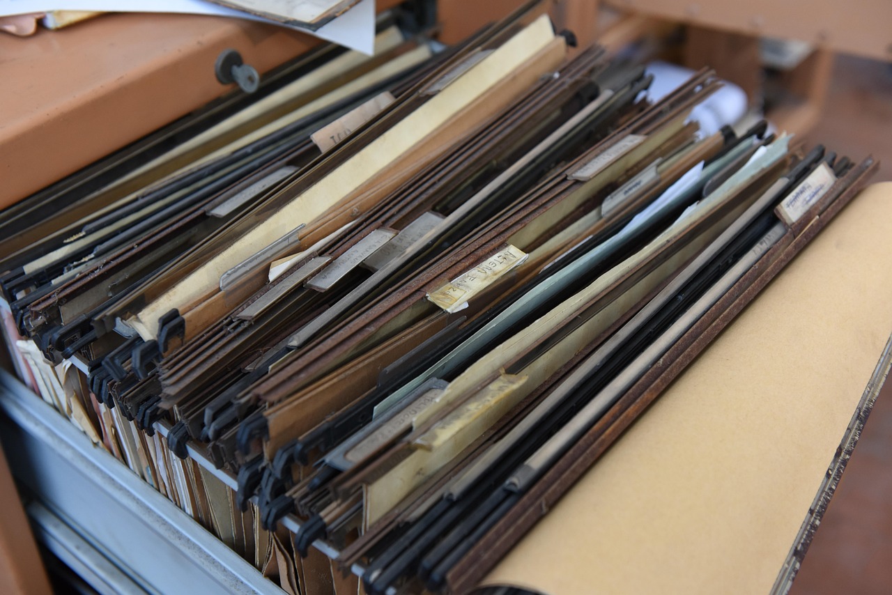 Neatly arranged file folders and documents on a professional office desk.