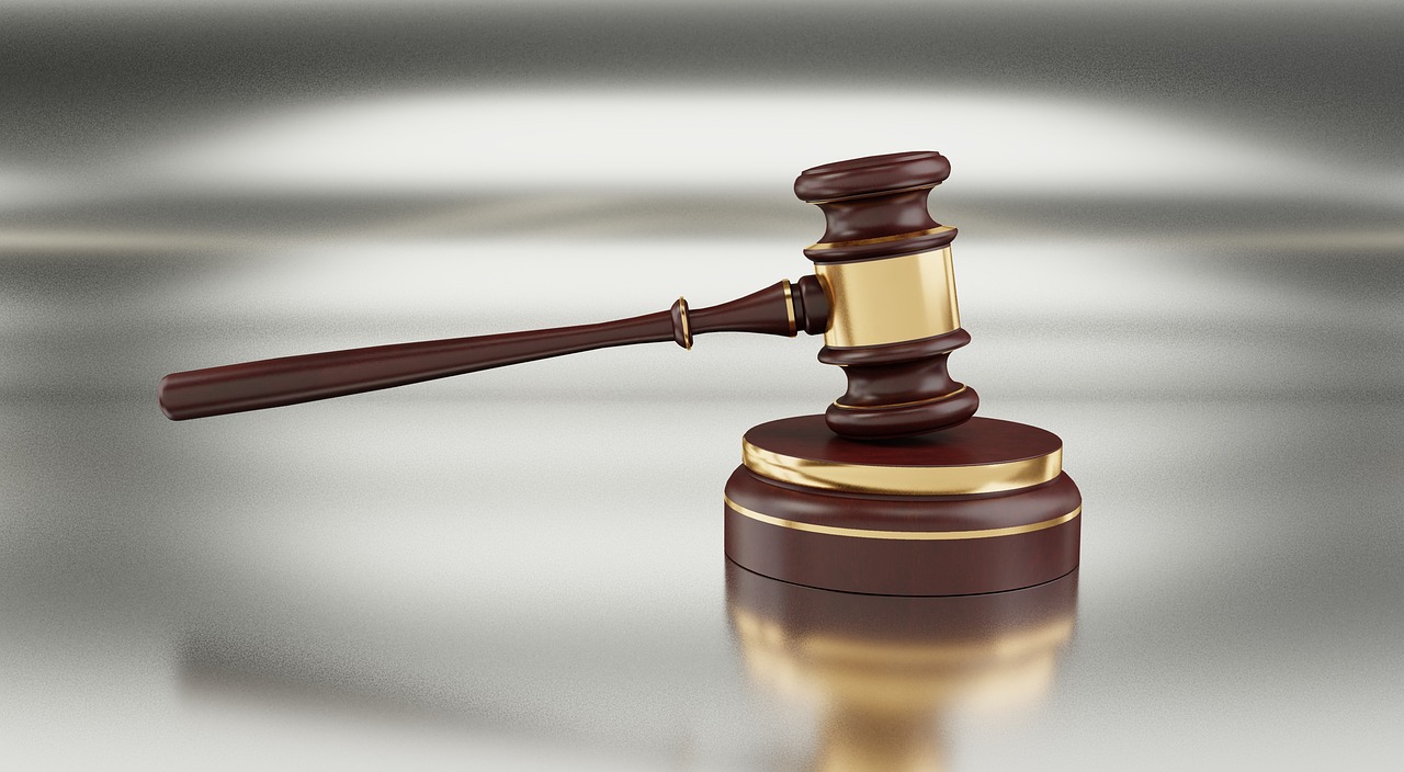 A legal gavel resting on financial tax forms representing court rulings.
