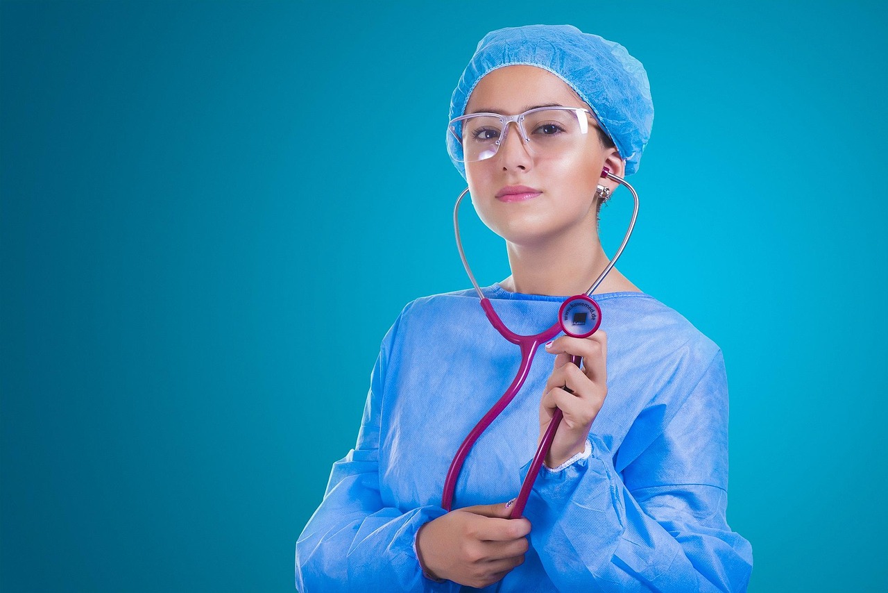 A stethoscope resting on a pile of coins symbolizing the intersection of health and finance.
