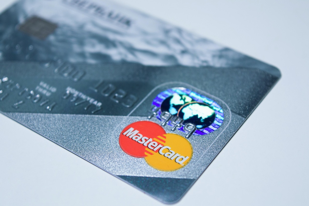 A person using a debit card for a transaction to illustrate payment rules.