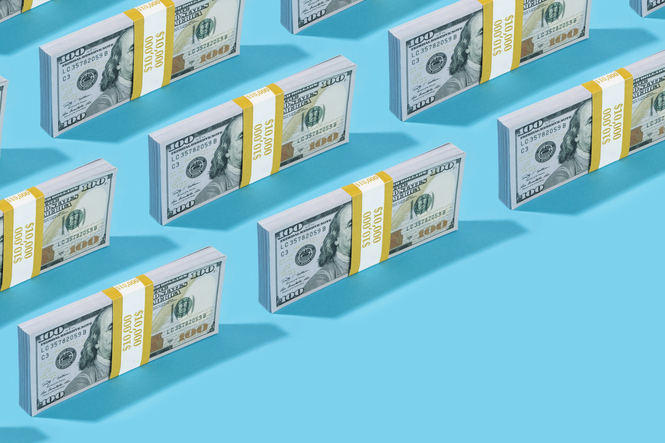 A repeating pattern of US hundred-dollar bills representing cash liquidity and savings growth.