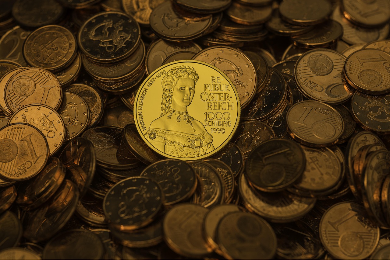 A hand stacking golden coins or blocks to represent a firm financial foundation and hierarchy of needs.