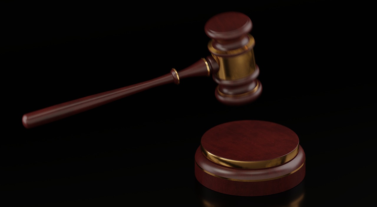 A wooden gavel resting on legal documents representing the SECURE 2.0 Act regulations.