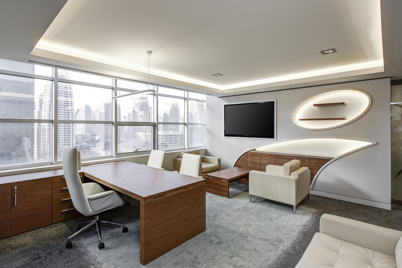 A wall calendar and a clock in a professional office setting highlighting the passage of time.