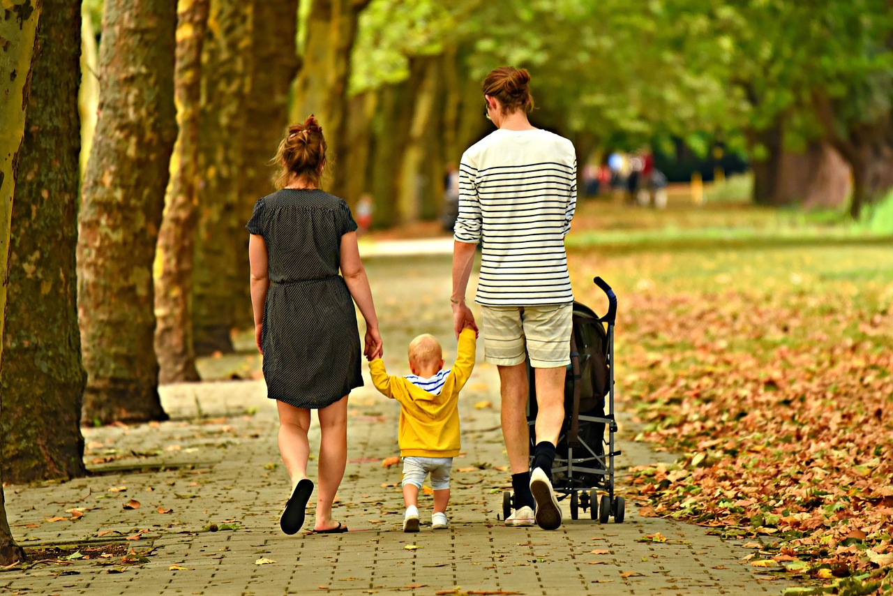 A family walking together in a lush green park representing multi-generational wealth planning.