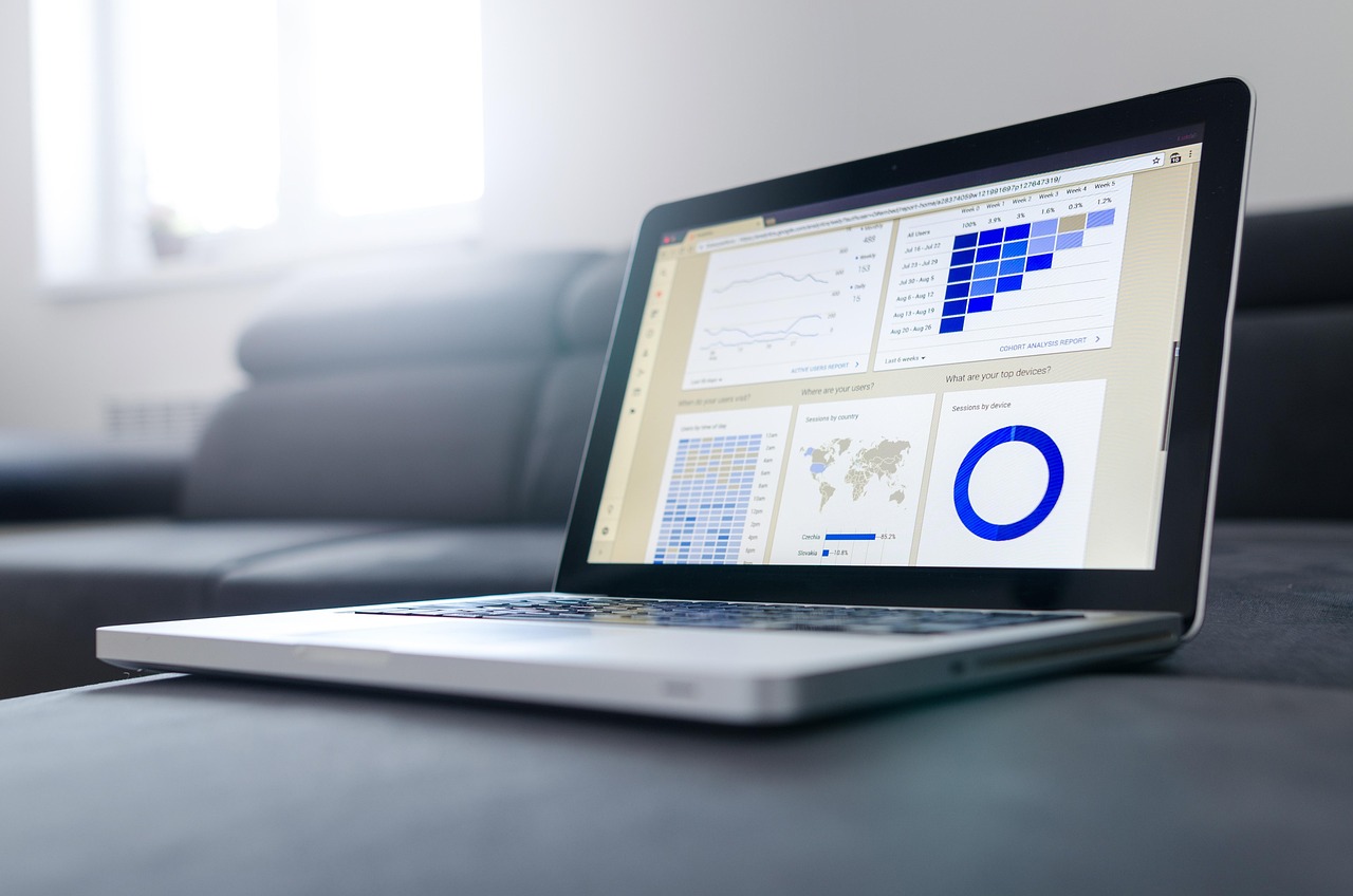 A person using a laptop to view a finance dashboard with clean UI elements.