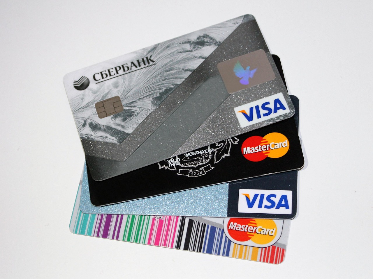 A person using a credit card for a contactless tap-to-pay transaction at a retail store.