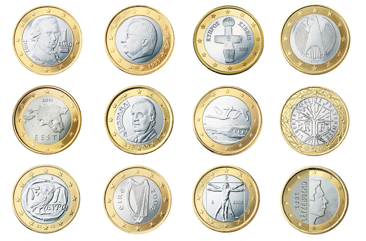 A set of brass scales balancing different amounts of coins, representing the choice between lump sum and dollar-cost averaging.