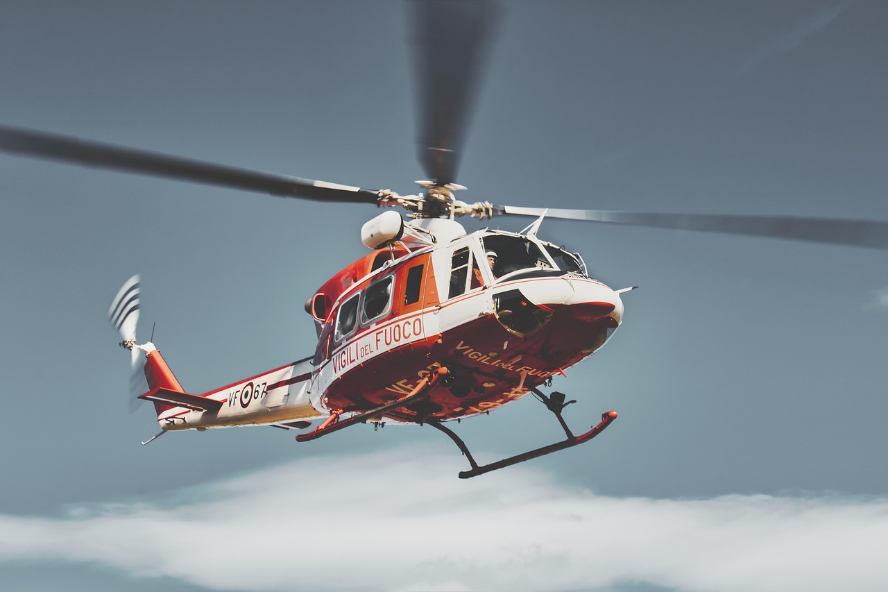 A medical rescue helicopter landing in a mountainous region.