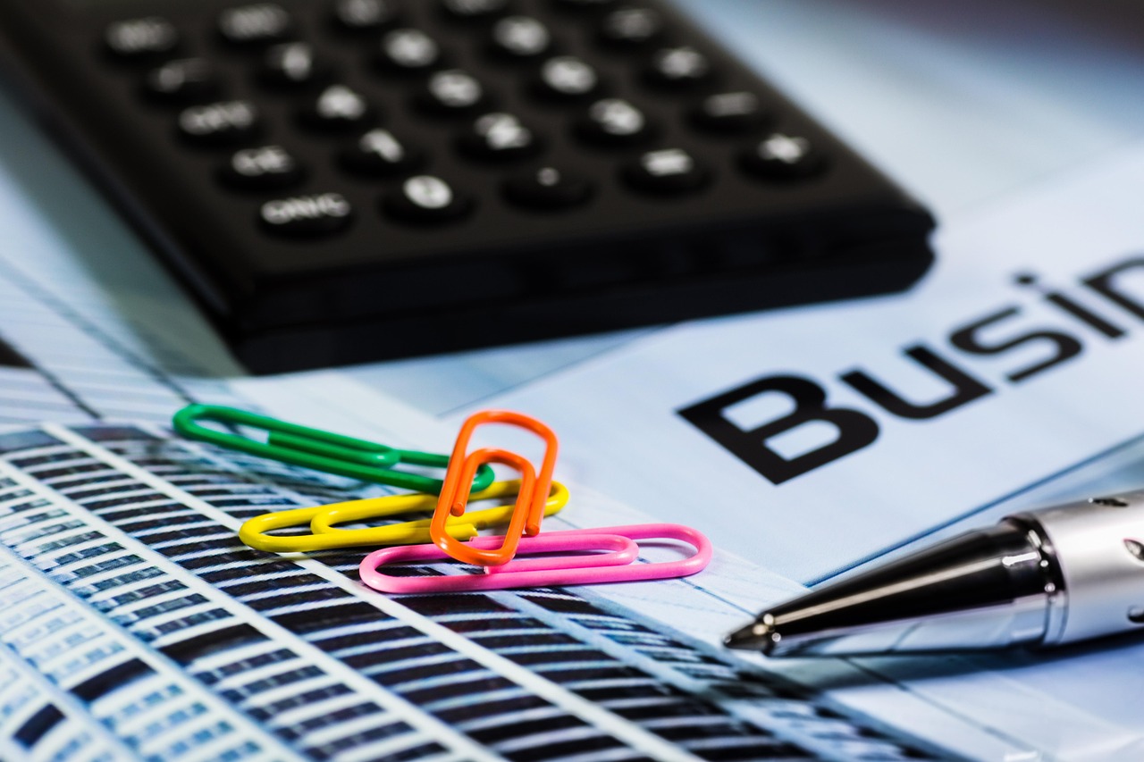 A workspace with a financial plan, a calculator, and a pen ready for action.